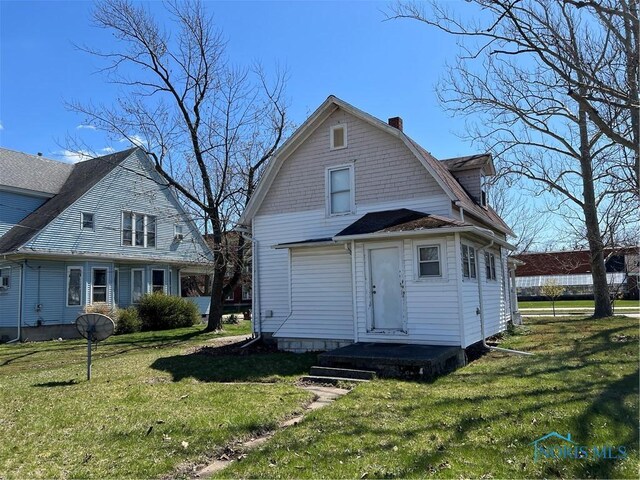 16 College Pl, Defiance, OH 43512 - rear view of property featuring a yard and a chimney