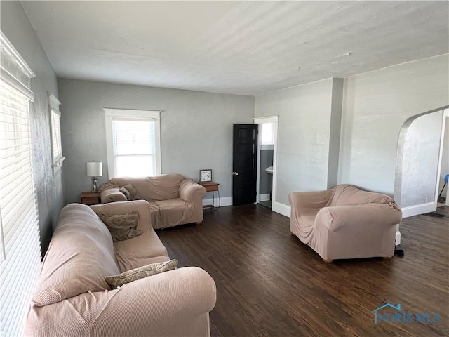16 College Pl, Defiance, OH 43512 - living area with arched walkways, dark wood-type flooring, and baseboards