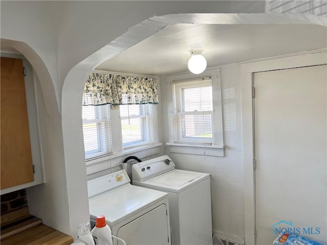 16 College Pl, Defiance, OH 43512 - laundry room featuring laundry area, washing machine and dryer, and arched walkways