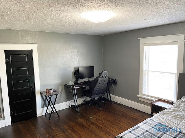 16 College Pl, Defiance, OH 43512 - bedroom featuring baseboards, multiple windows, a textured ceiling, and wood finished floors