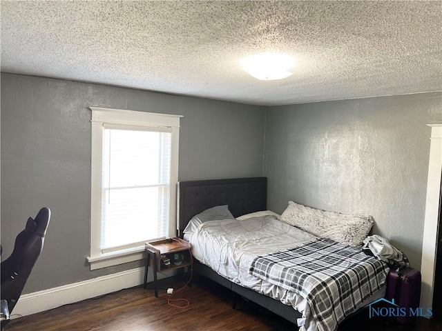 16 College Pl, Defiance, OH 43512 - bedroom with a textured wall, multiple windows, wood finished floors, and a textured ceiling