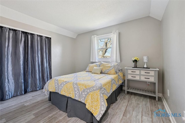 5808 President Dr, Toledo, OH 43611 - bedroom featuring vaulted ceiling and wood finished floors