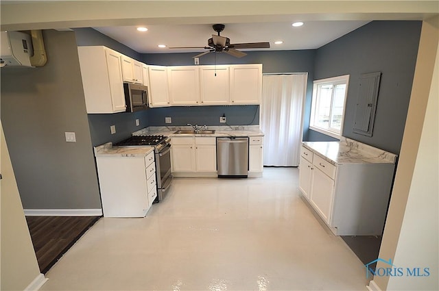 1964 Sudbury Dr, Holland, OH 43528 - kitchen with an AC wall unit, white cabinetry, a ceiling fan, appliances with stainless steel finishes, and a sink