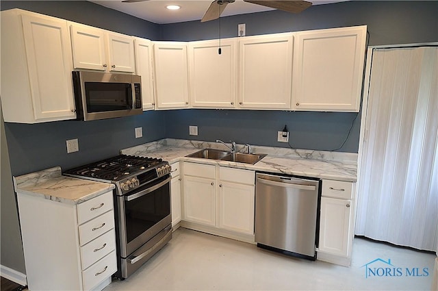 1964 Sudbury Dr, Holland, OH 43528 - kitchen with a sink, a ceiling fan, white cabinets, and stainless steel appliances
