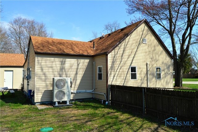 1964 Sudbury Dr, Holland, OH 43528 - back of house with roof with shingles, fence, and a lawn