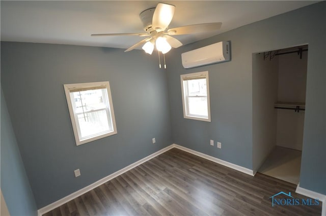 1964 Sudbury Dr, Holland, OH 43528 - unfurnished bedroom featuring dark wood finished floors, baseboards, ceiling fan, and a wall unit AC