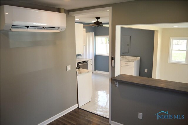 1964 Sudbury Dr, Holland, OH 43528 - kitchen with baseboards, electric panel, dishwasher, ceiling fan, and a wall mounted AC