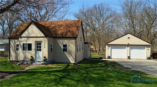 1964 Sudbury Dr, Holland, OH 43528 - view of front facade featuring a front lawn, a garage, and an outdoor structure