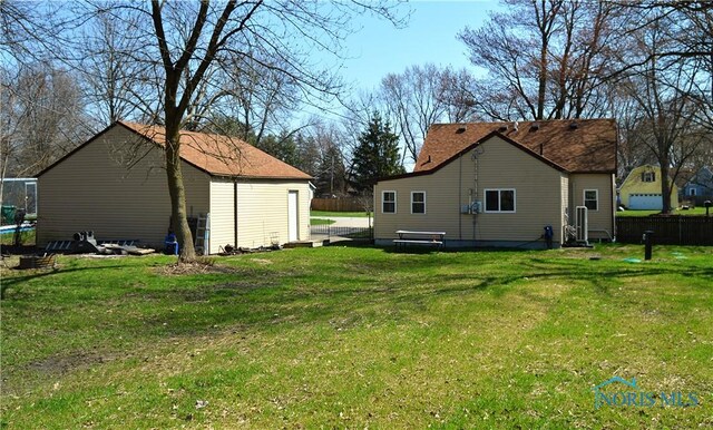 1964 Sudbury Dr, Holland, OH 43528 - back of property with fence, an outdoor structure, and a lawn