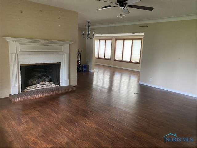 unfurnished living room with a fireplace with raised hearth, baseboards, ceiling fan with notable chandelier, crown molding, and wood finished floors
