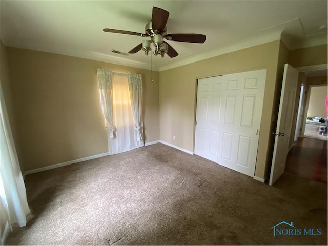 unfurnished bedroom featuring baseboards, a closet, visible vents, and carpet floors