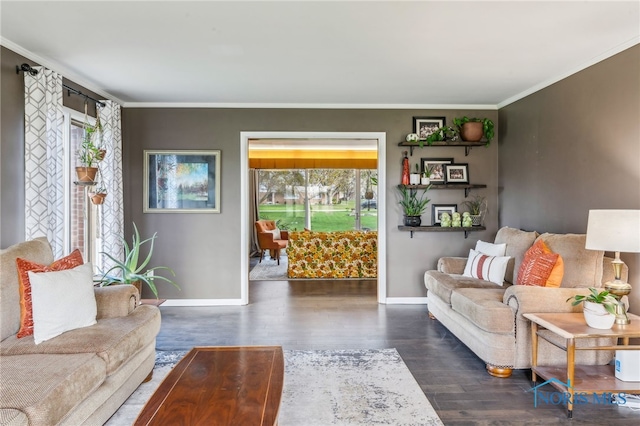 living area with crown molding, baseboards, and wood finished floors