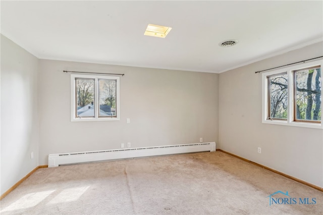 carpeted spare room with crown molding, baseboards, visible vents, and baseboard heating