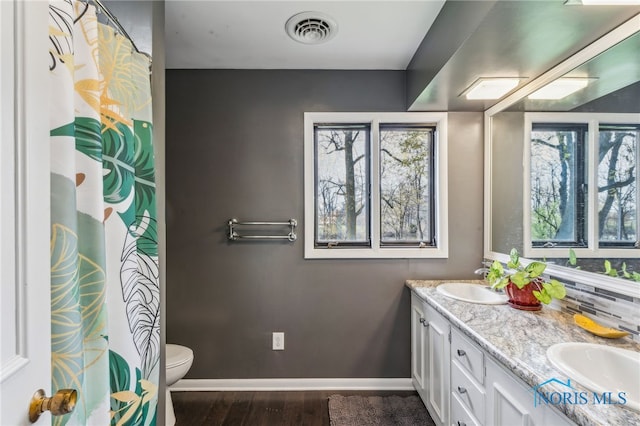 bathroom featuring a sink, a healthy amount of sunlight, and visible vents