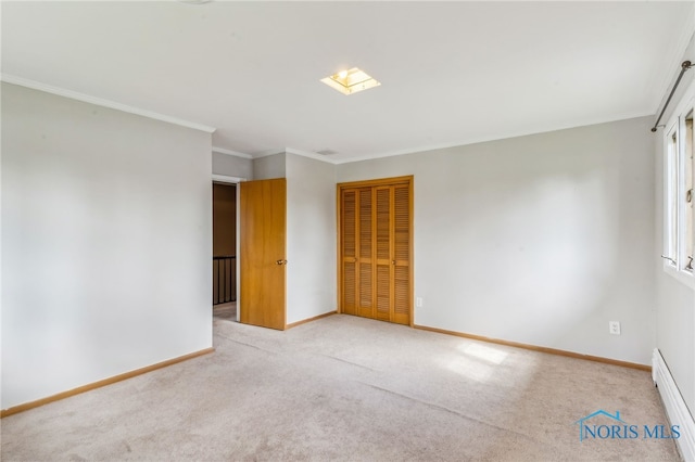 unfurnished room with baseboards, carpet flooring, and a baseboard heating unit