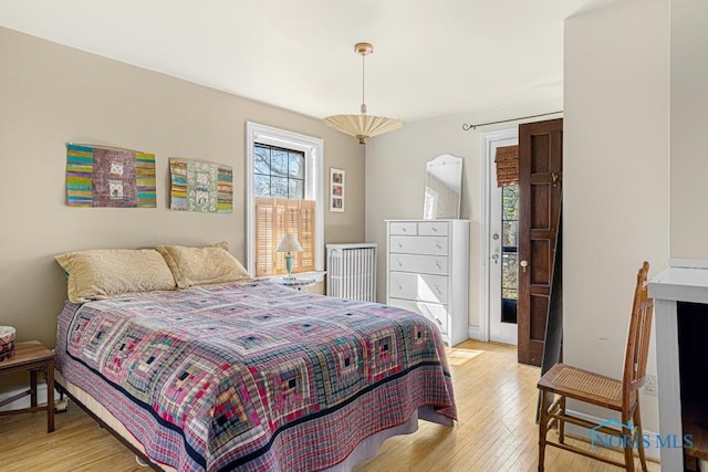 bedroom with light wood-style flooring and access to exterior
