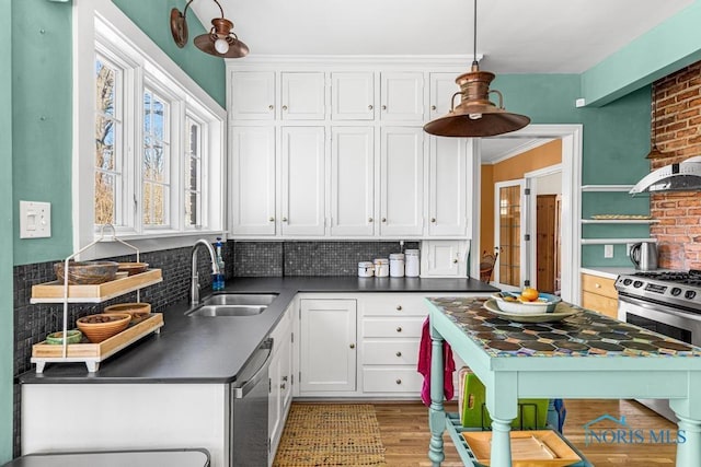 kitchen featuring a sink, white cabinets, appliances with stainless steel finishes, and dark countertops