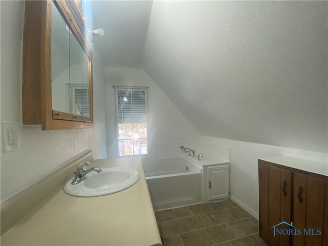 715 Raymer Blvd, Toledo, OH 43605 - bathroom with vanity, a garden tub, and lofted ceiling
