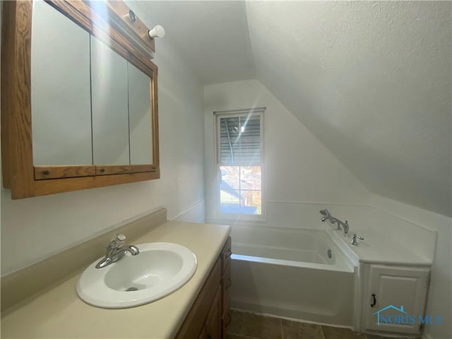 715 Raymer Blvd, Toledo, OH 43605 - full bath with vanity, vaulted ceiling, and a garden tub