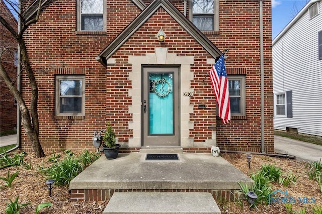view of exterior entry with brick siding