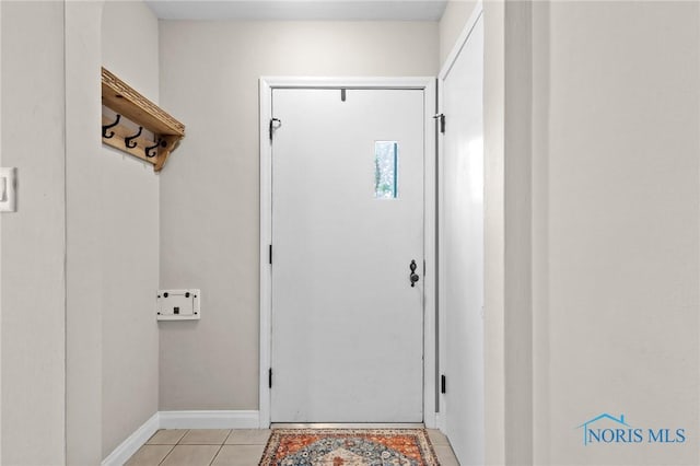 entryway featuring light tile patterned flooring and baseboards