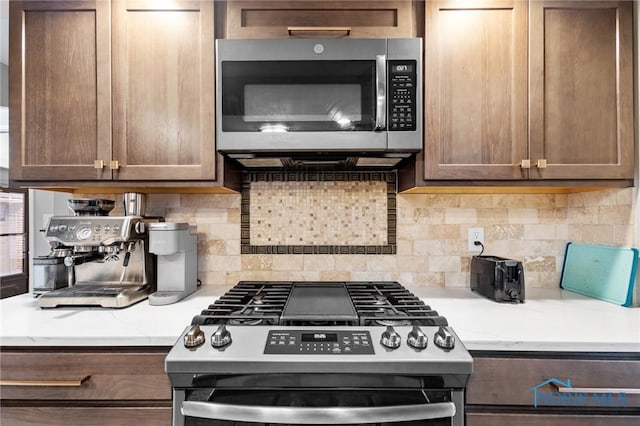 kitchen featuring appliances with stainless steel finishes and decorative backsplash