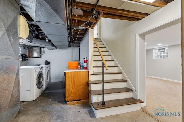 basement with electric panel, stairway, and washer and clothes dryer