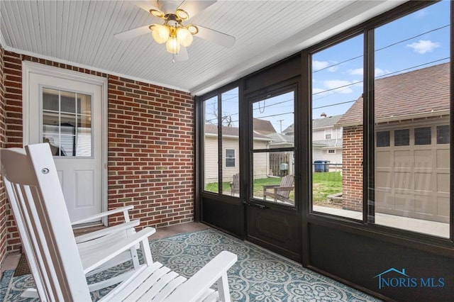 sunroom featuring a ceiling fan