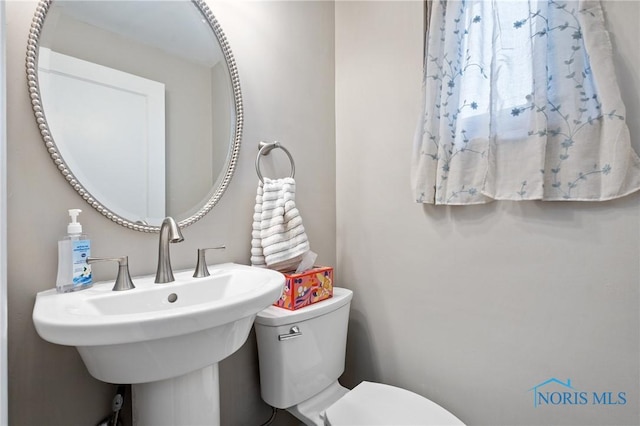 half bathroom with a sink and toilet