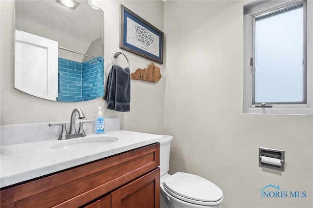 full bathroom with a shower, vanity, and toilet