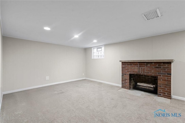 unfurnished living room featuring visible vents, recessed lighting, carpet, and a brick fireplace