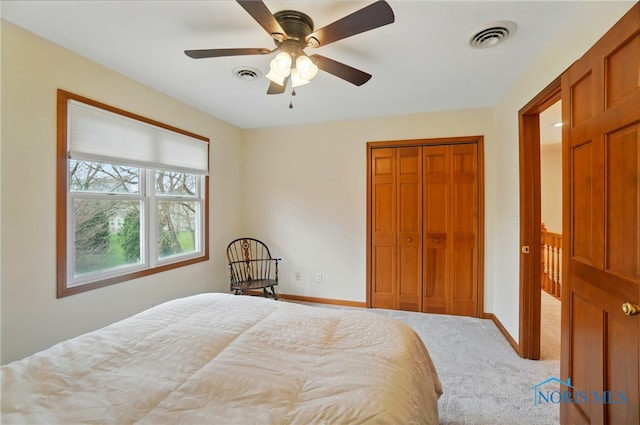 carpeted bedroom featuring visible vents, baseboards, a closet, and ceiling fan