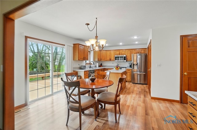 dining space featuring an inviting chandelier, visible vents, recessed lighting, light wood finished floors, and baseboards