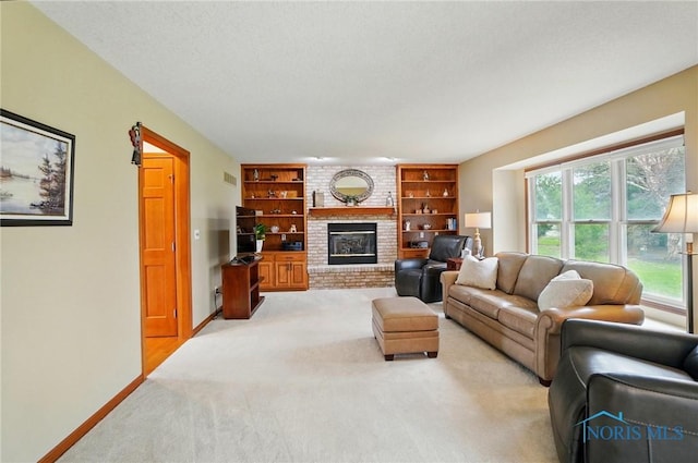 living room with a wealth of natural light, a brick fireplace, light carpet, and baseboards
