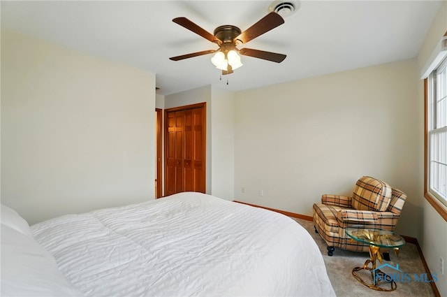 bedroom featuring a closet, baseboards, carpet flooring, visible vents, and ceiling fan