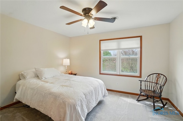 carpeted bedroom with visible vents, baseboards, and a ceiling fan