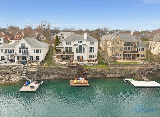 drone / aerial view featuring a water view and a residential view