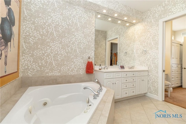 bathroom featuring double vanity, visible vents, wallpapered walls, a jetted tub, and tile patterned flooring