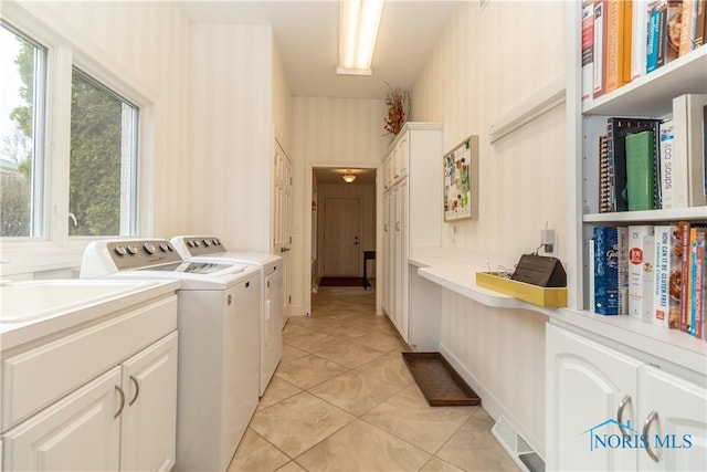 laundry area with washing machine and dryer, cabinet space, visible vents, and light tile patterned floors