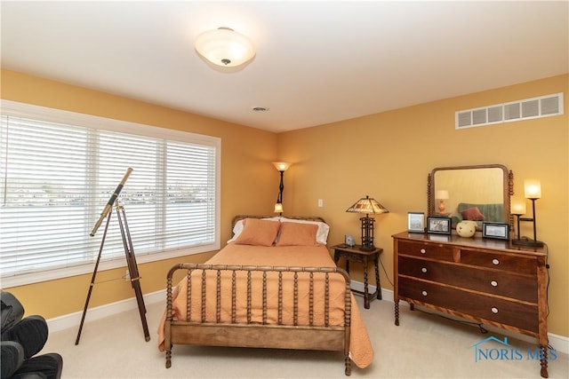 bedroom featuring baseboards, visible vents, and carpet flooring