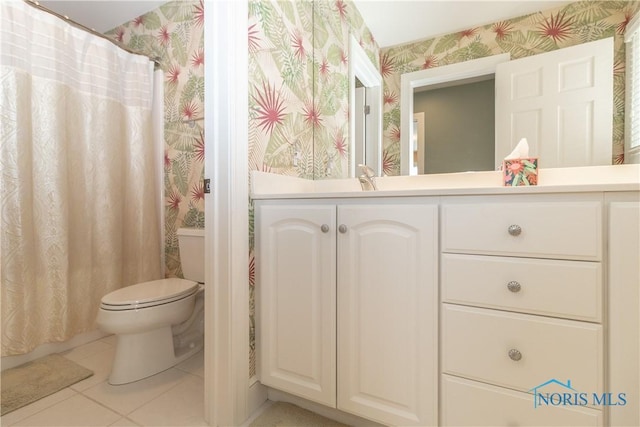 bathroom featuring wallpapered walls, toilet, vanity, and tile patterned floors