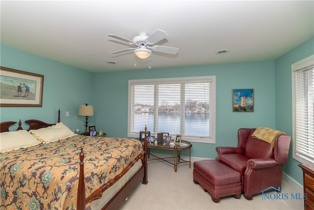 bedroom featuring light colored carpet, baseboards, a ceiling fan, and visible vents