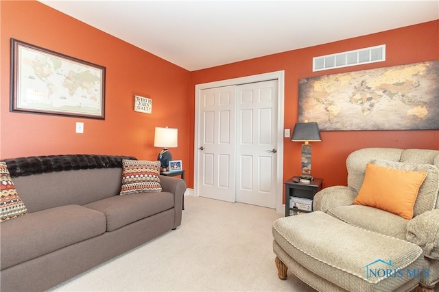living area with light carpet, visible vents, and baseboards