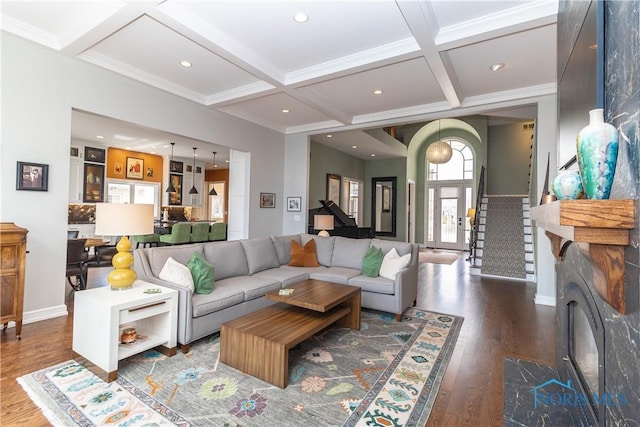 living room featuring beam ceiling, recessed lighting, coffered ceiling, wood finished floors, and stairway