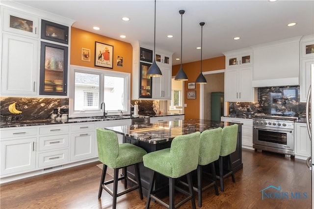 kitchen with decorative backsplash, high end stainless steel range oven, dark wood-type flooring, and recessed lighting