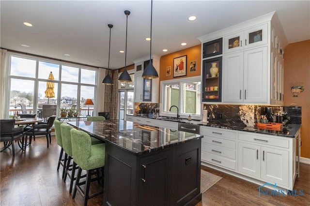 kitchen with dishwashing machine, a healthy amount of sunlight, and tasteful backsplash