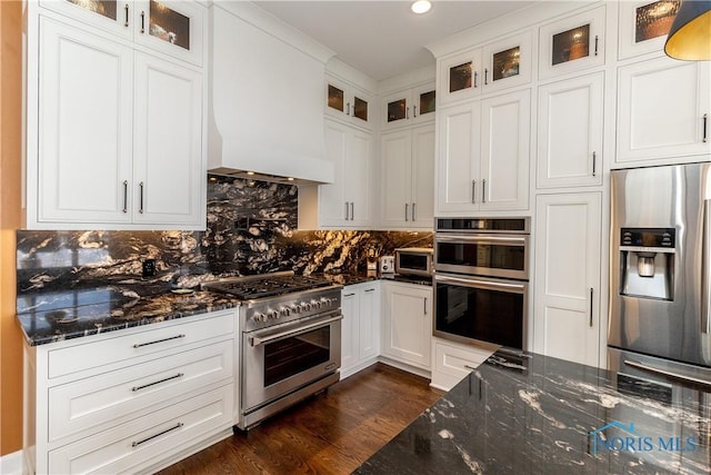 kitchen with premium range hood, dark wood finished floors, stainless steel appliances, and white cabinets