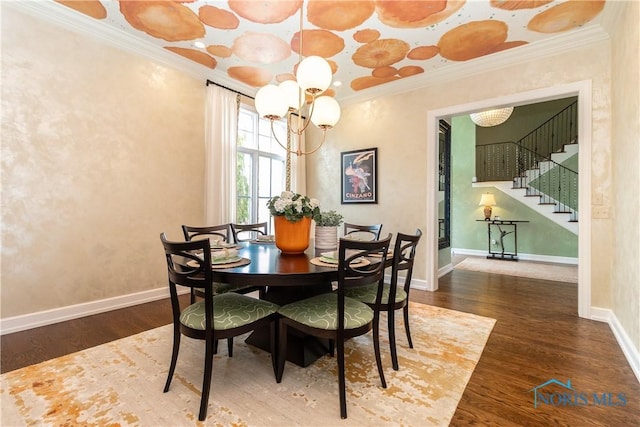 dining room with stairs, crown molding, wood finished floors, and baseboards