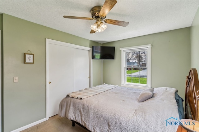 242 E Yates Ave, Findlay, OH 45840 - carpeted bedroom with a closet, ceiling fan, a textured ceiling, and baseboards