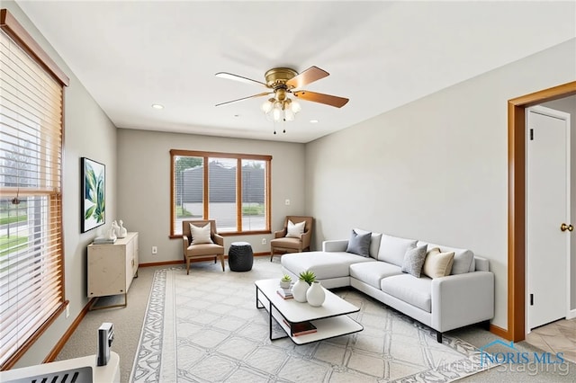 242 E Yates Ave, Findlay, OH 45840 - living room with a ceiling fan, baseboards, and light colored carpet